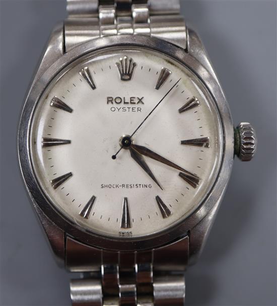 A gentlemans 1950s stainless steel Rolex Oyster manual wind wrist watch, on associated stainless steel bracelet,